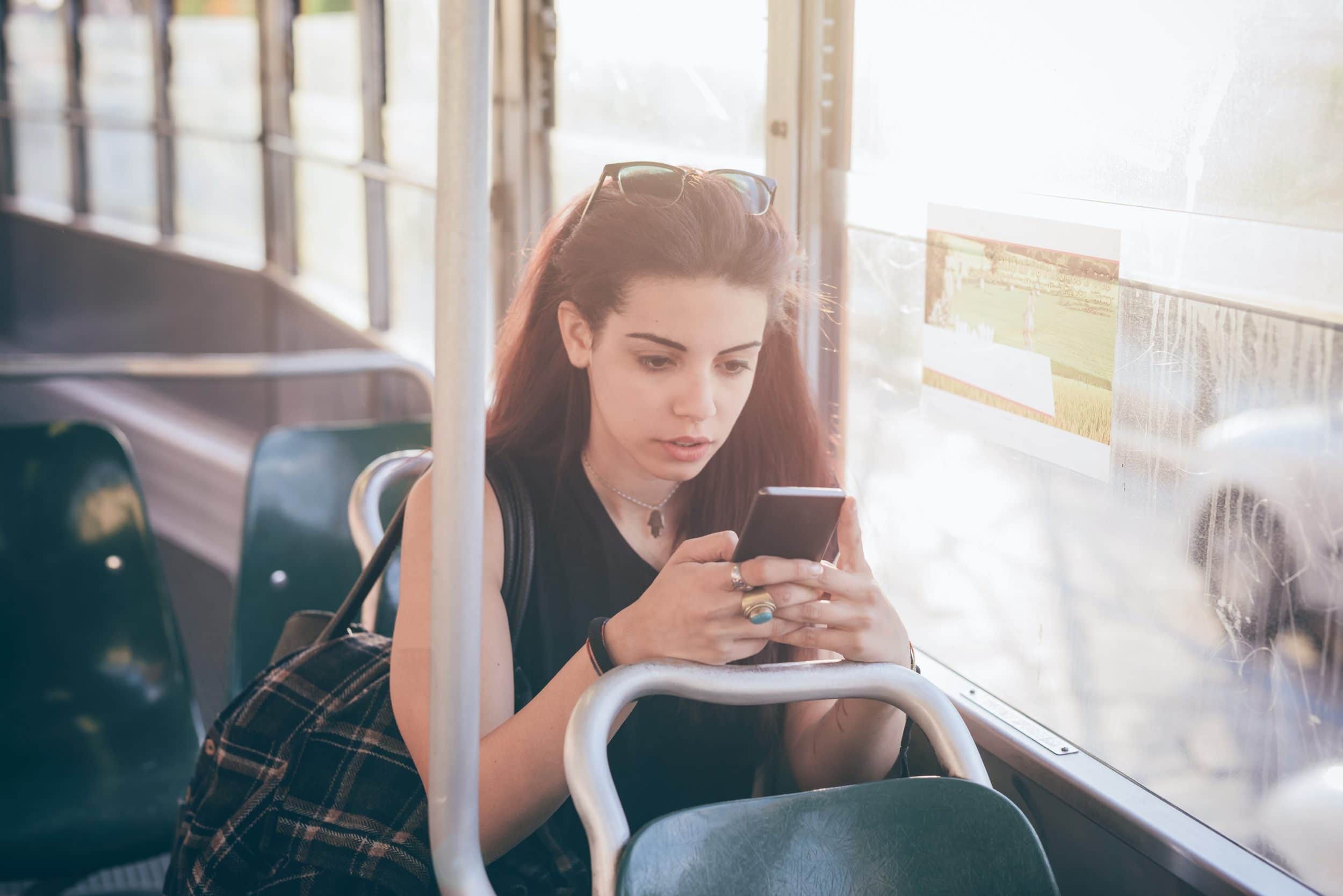 woman-using-a-smartphone-on-a-train